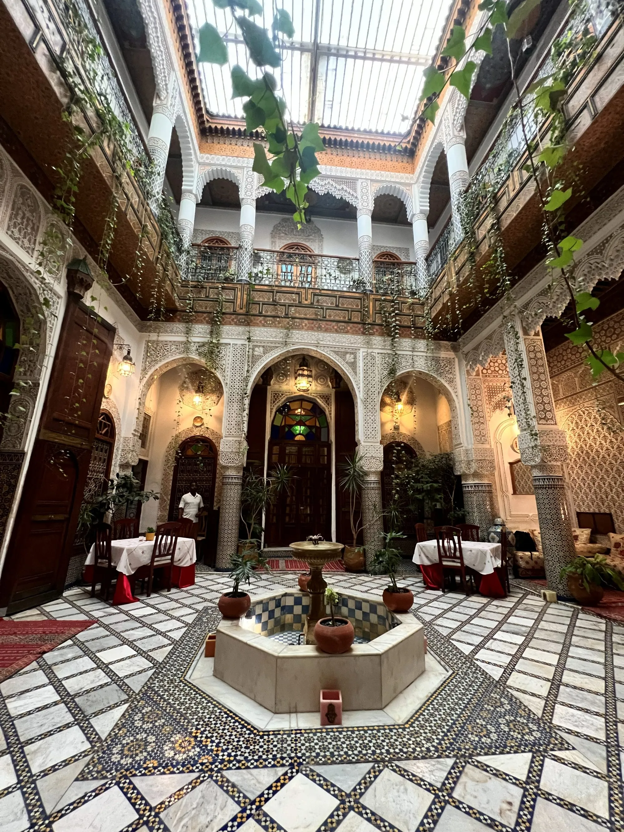The ornate tiled courtyard of a traditional riad in Fès