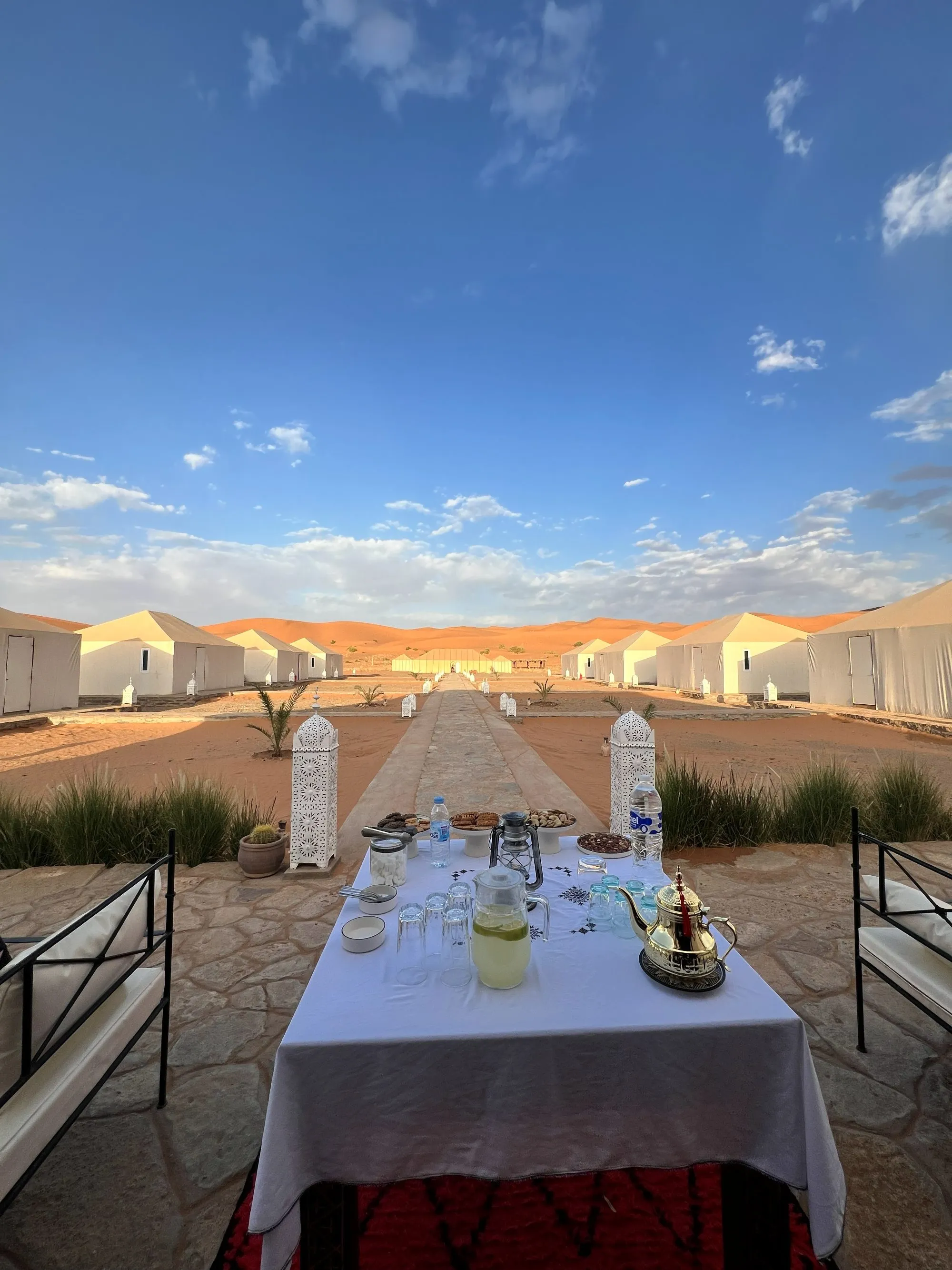 An elegant private dinner set up in the Sahara at sunset