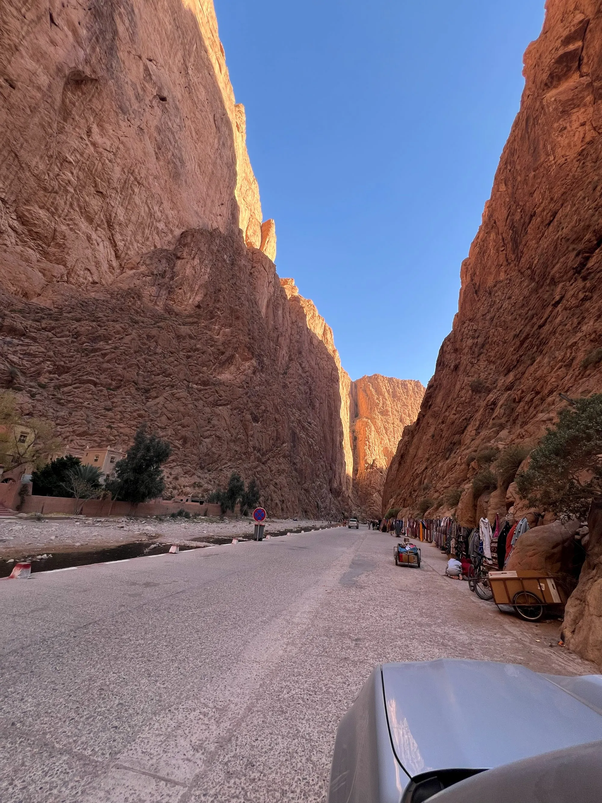 The road winding beneath the towering red cliffs of Todra Gorge